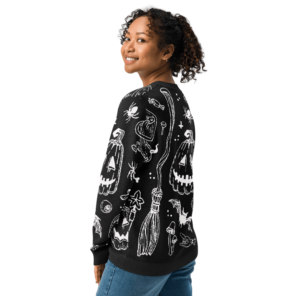 Black knit crewneck sweater with white Halloween-style characters on the back, long sleeves