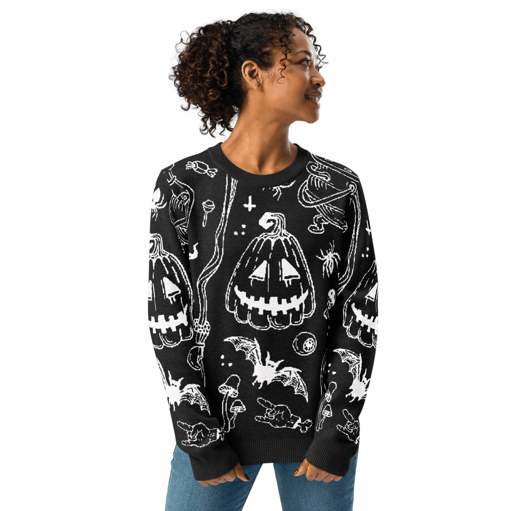 Black crewneck knit sweater with white Halloween icons, long sleeves, and ribbed hem