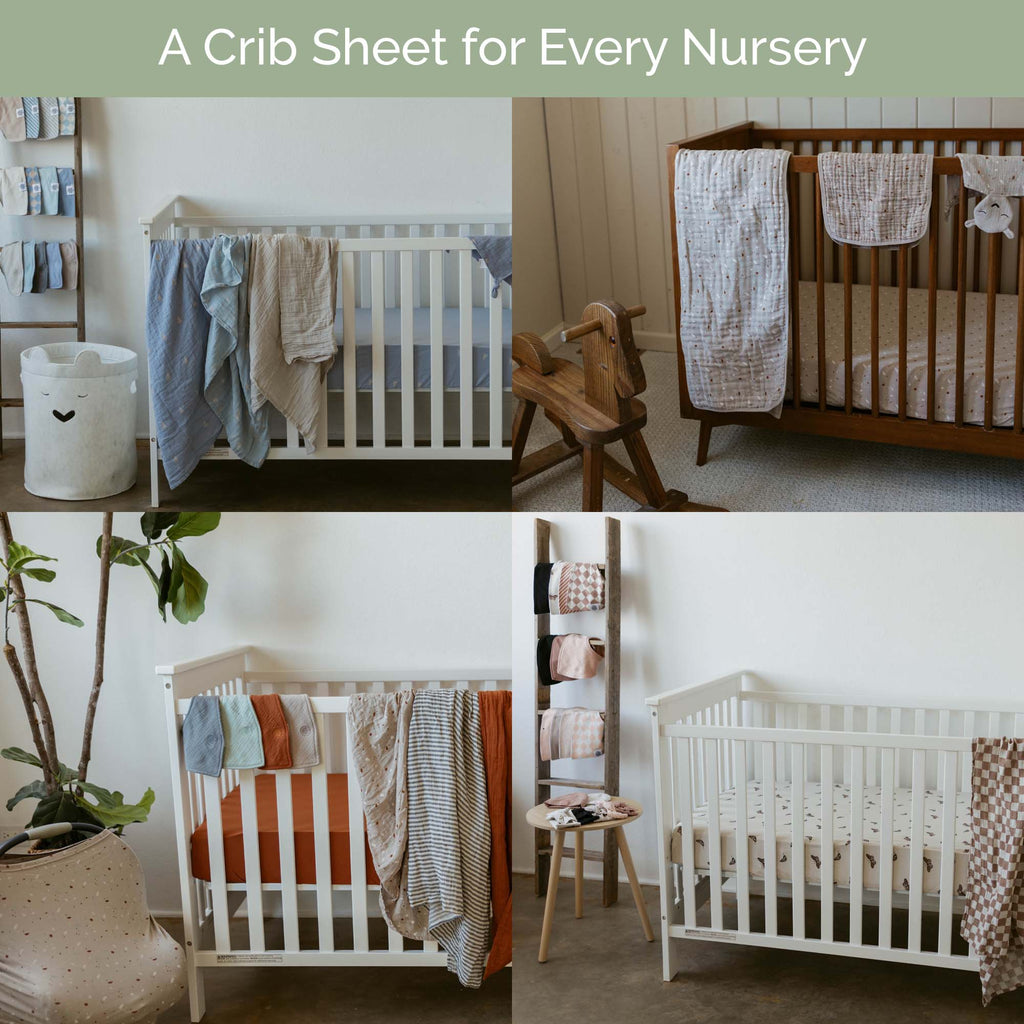 Assorted crib sheets hanging in a nursery on a rail, showing various patterns.