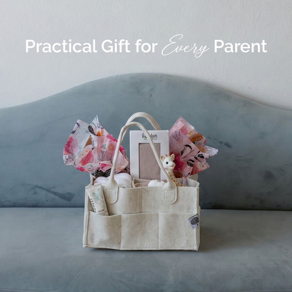 Crib sheet gift set in a fabric tote bag with folded pastel sheets and small toys.