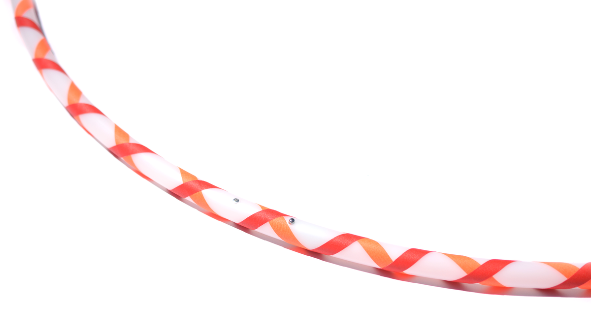Beginner hula hoop with red and orange spiral gaffer tape on white tubing