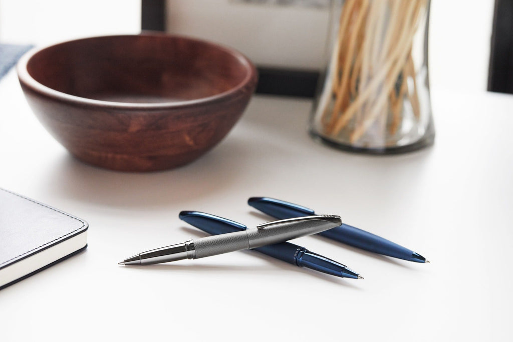 Set of dark blue ballpoint pens with textured barrels and metal tips