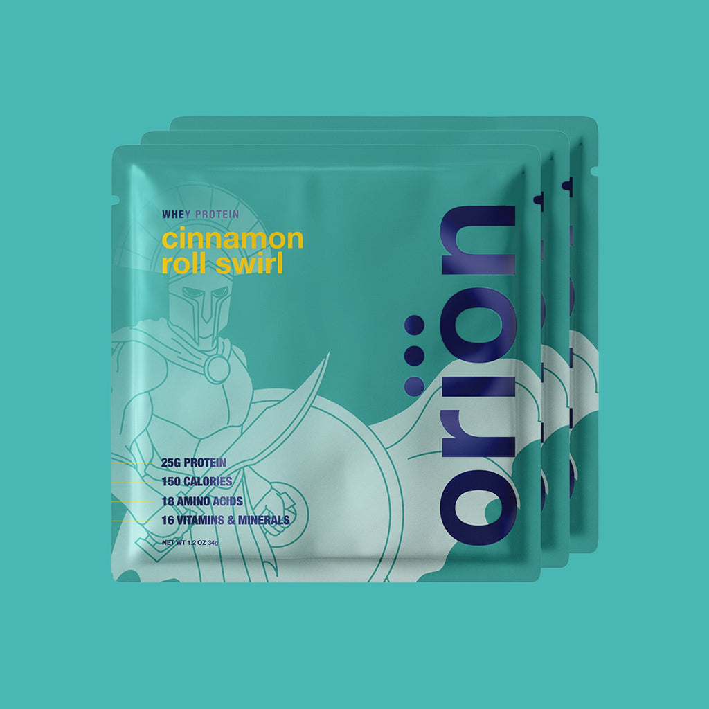 Teal protein sample packs labeled cinnamon roll swirl