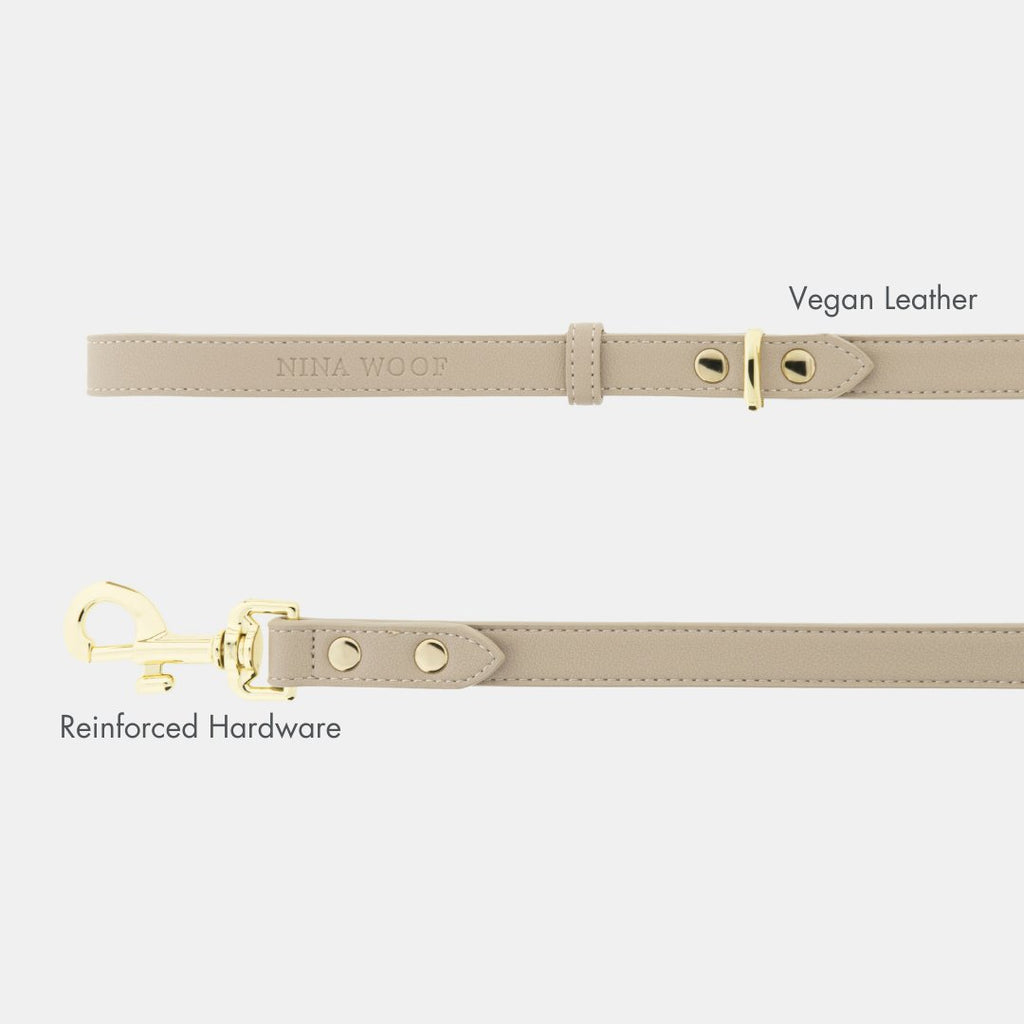 Beige vegan leather dog leash with adjustable holes and reinforced metal hardware