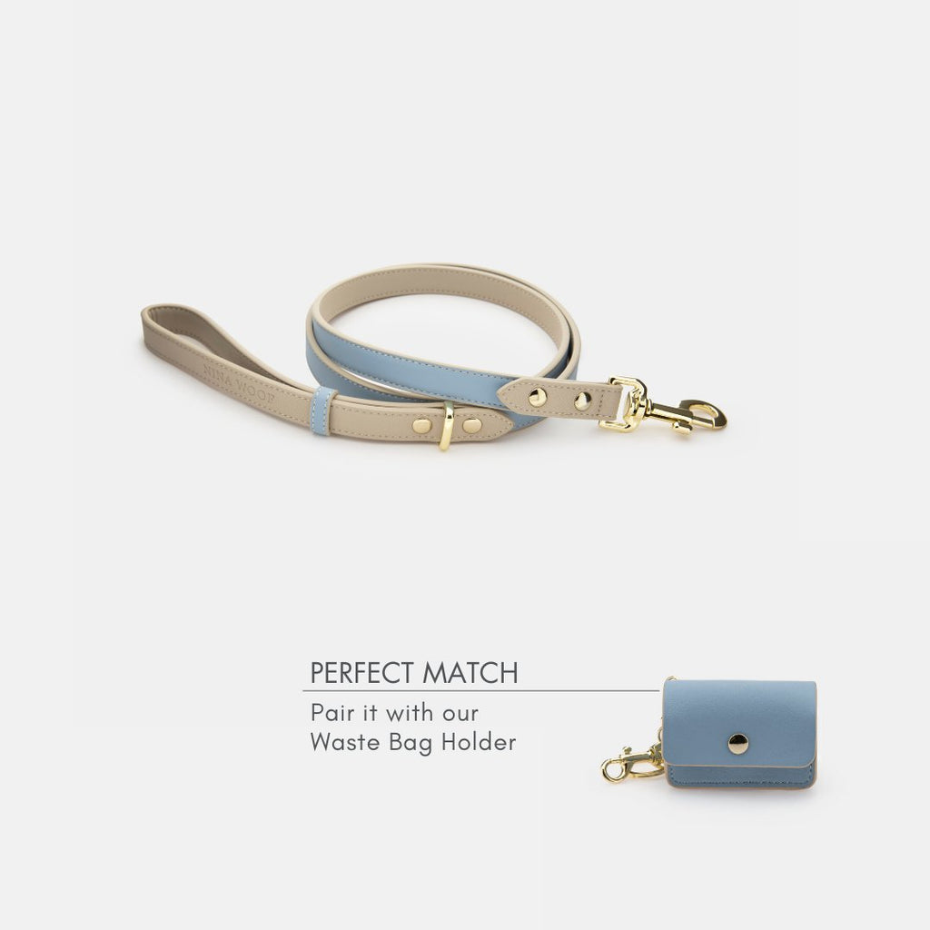 Light blue vegan leather dog leash with matching waste bag holder and gold-tone hardware