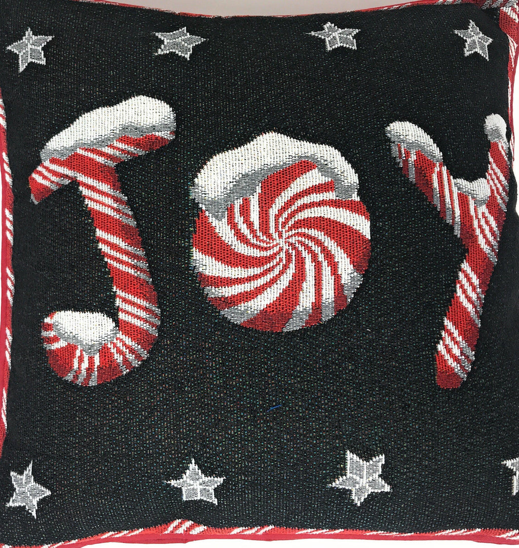 Black throw pillow cover with large peppermint circle, candy cane stripes, and stars