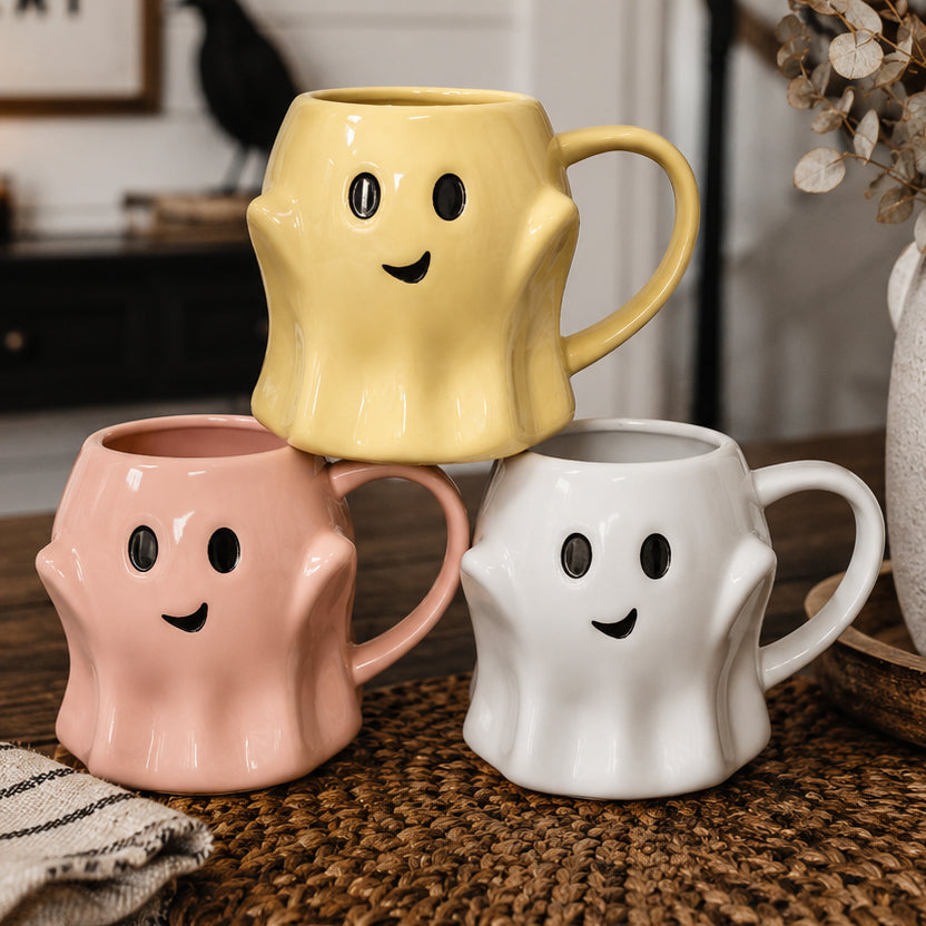 Set of three ghost-shaped mugs with smiley face, pink, white, and yellow