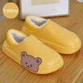 Yellow slip-on slippers with fuzzy lining and cute bear face applique