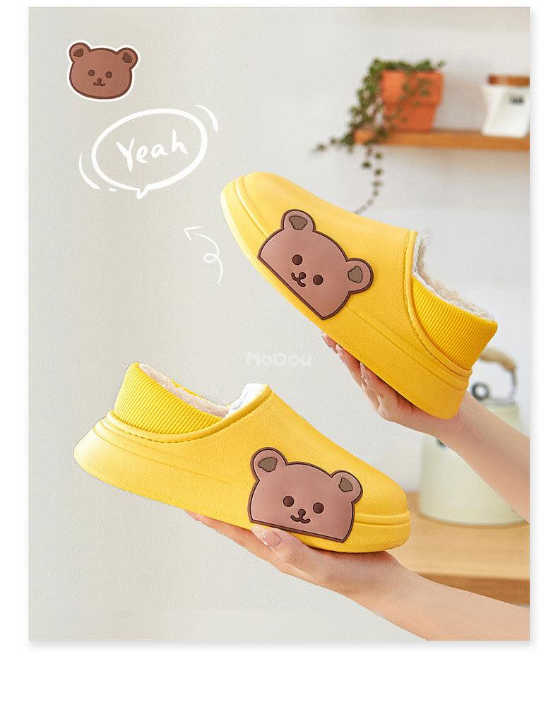 Yellow slip-on slippers with plush lining and bear face patch on side