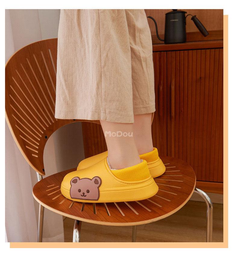 Yellow slip-on slippers with plush lining and bear patch detail