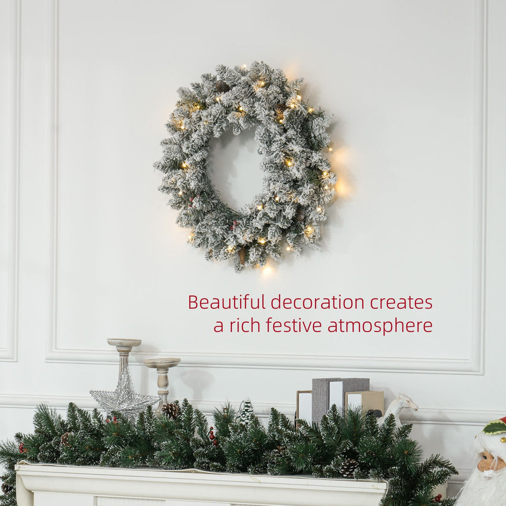 Snow-flocked pre-lit door wreath with warm white LED lights and pinecone accents