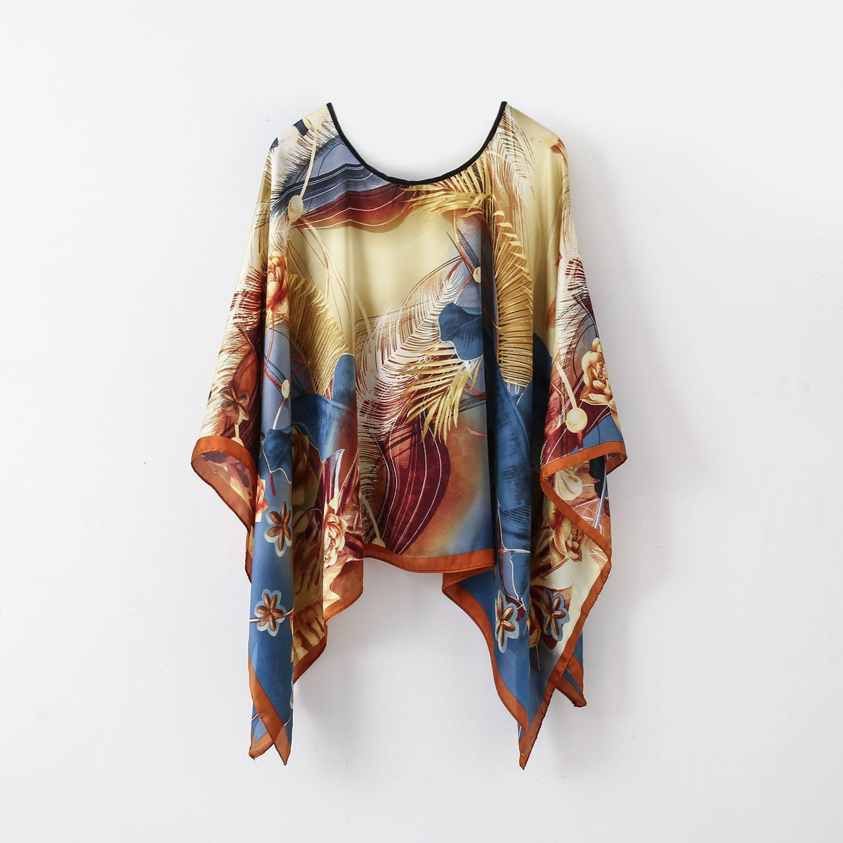 Gold, blue, and rust abstract wrap poncho shawl with fringe hem and round neckline