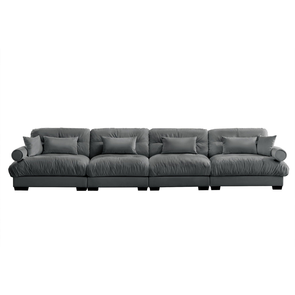 Dark gray modular sectional sofa with deep cushions, rolled arms, and low block legs