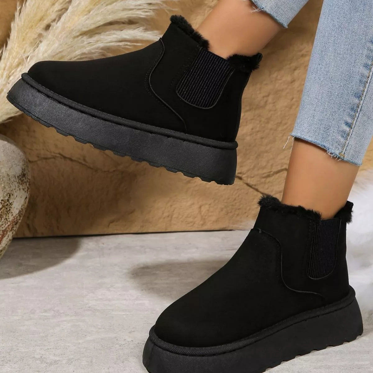 Black platform ankle boots with faux fur cuff and elastic gore detail