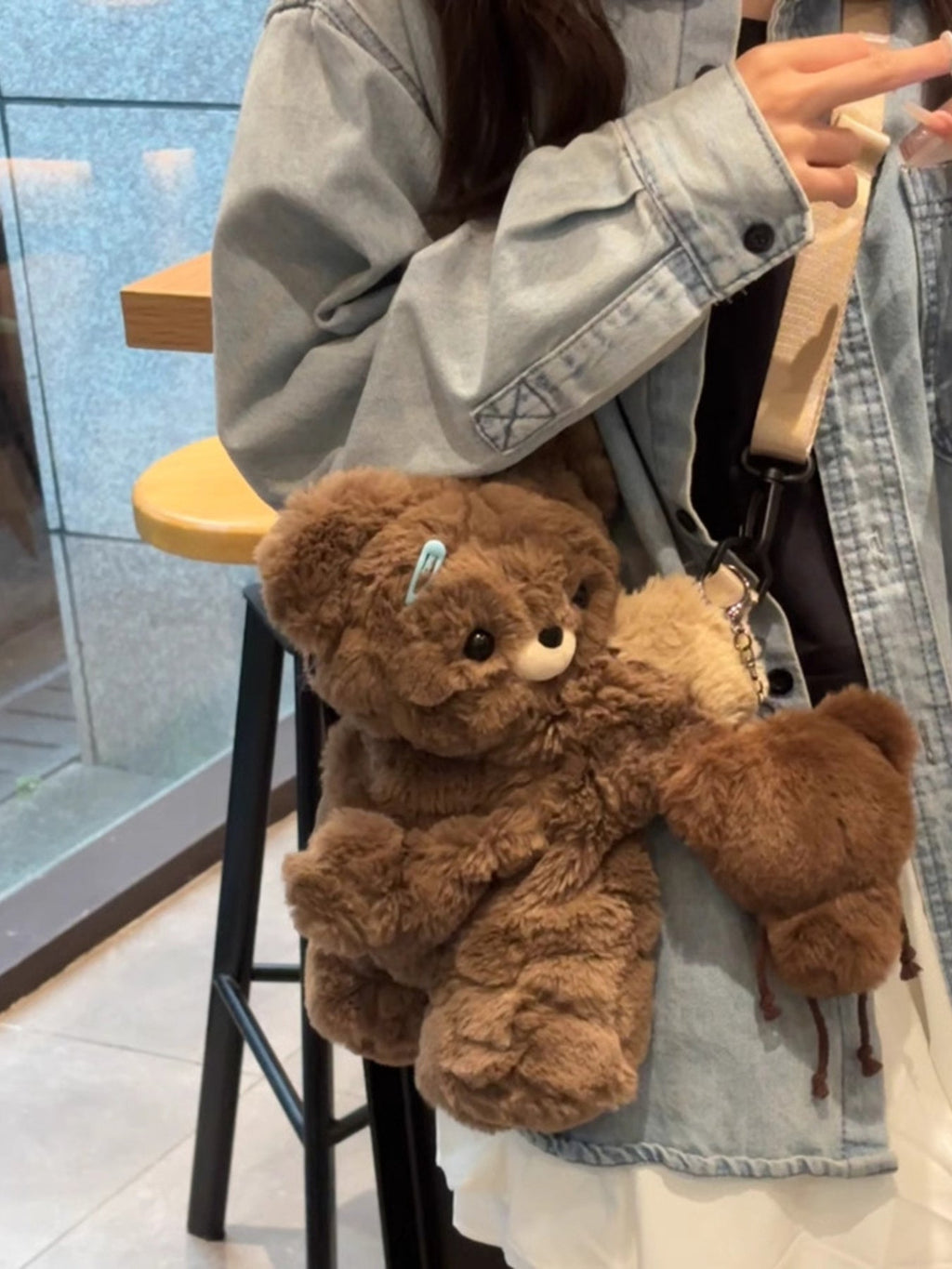 Brown plush teddy bear backpack bag with teddy bear head detail and small bear charm