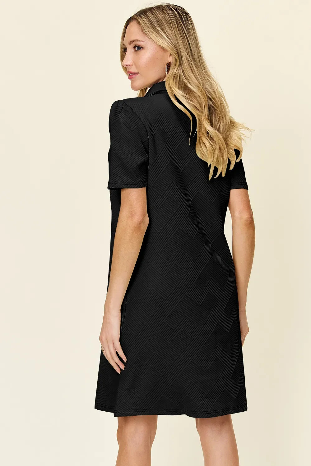 Black textured collared short-sleeve dress with a V neckline, above-knee length.