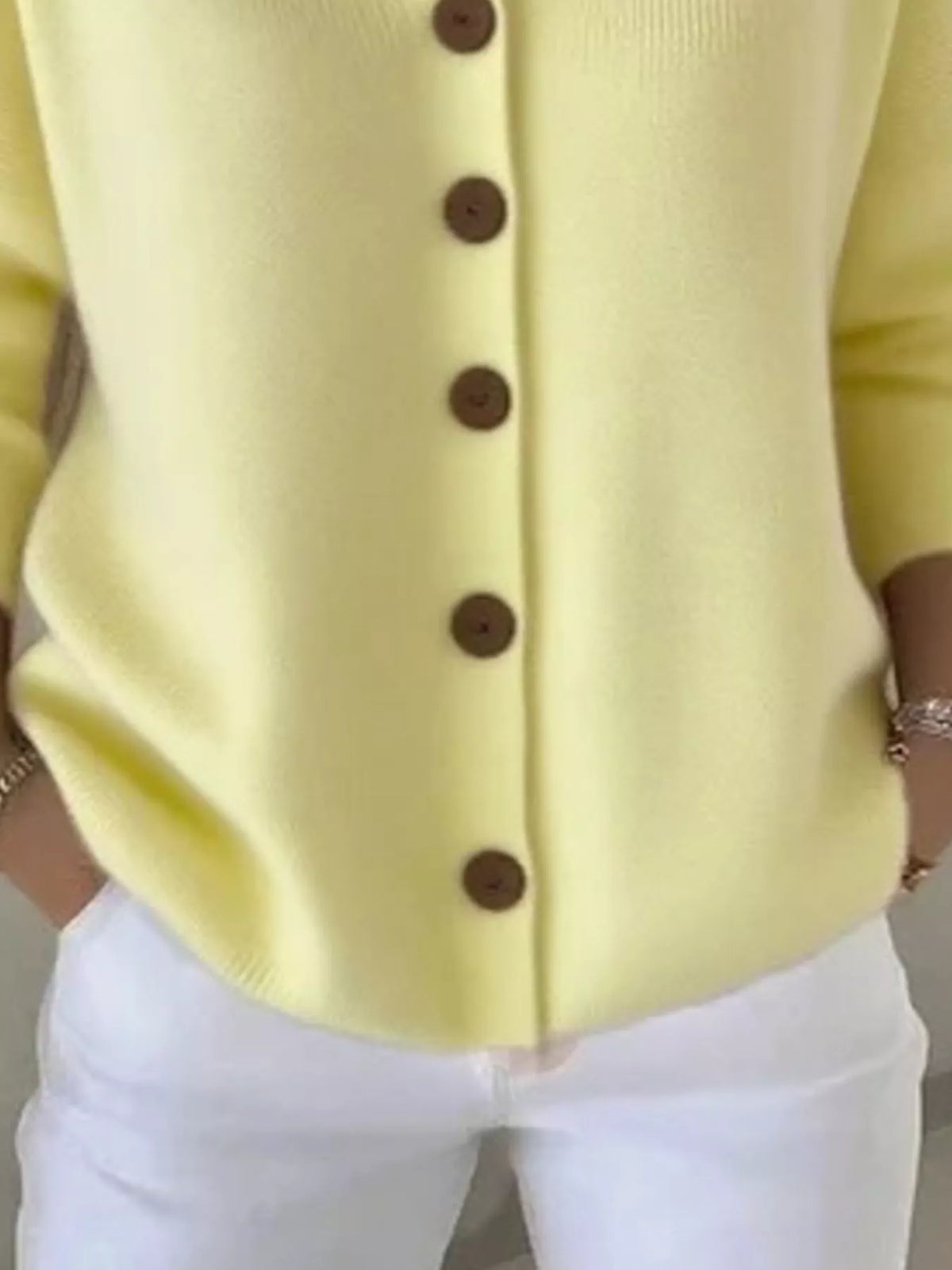 Light yellow hooded knit cardigan with button front and ribbed hem, long sleeves