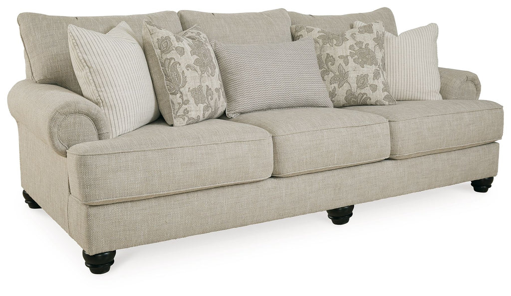 Fog sofa angled view in light beige fabric with dark legs and throw pillows