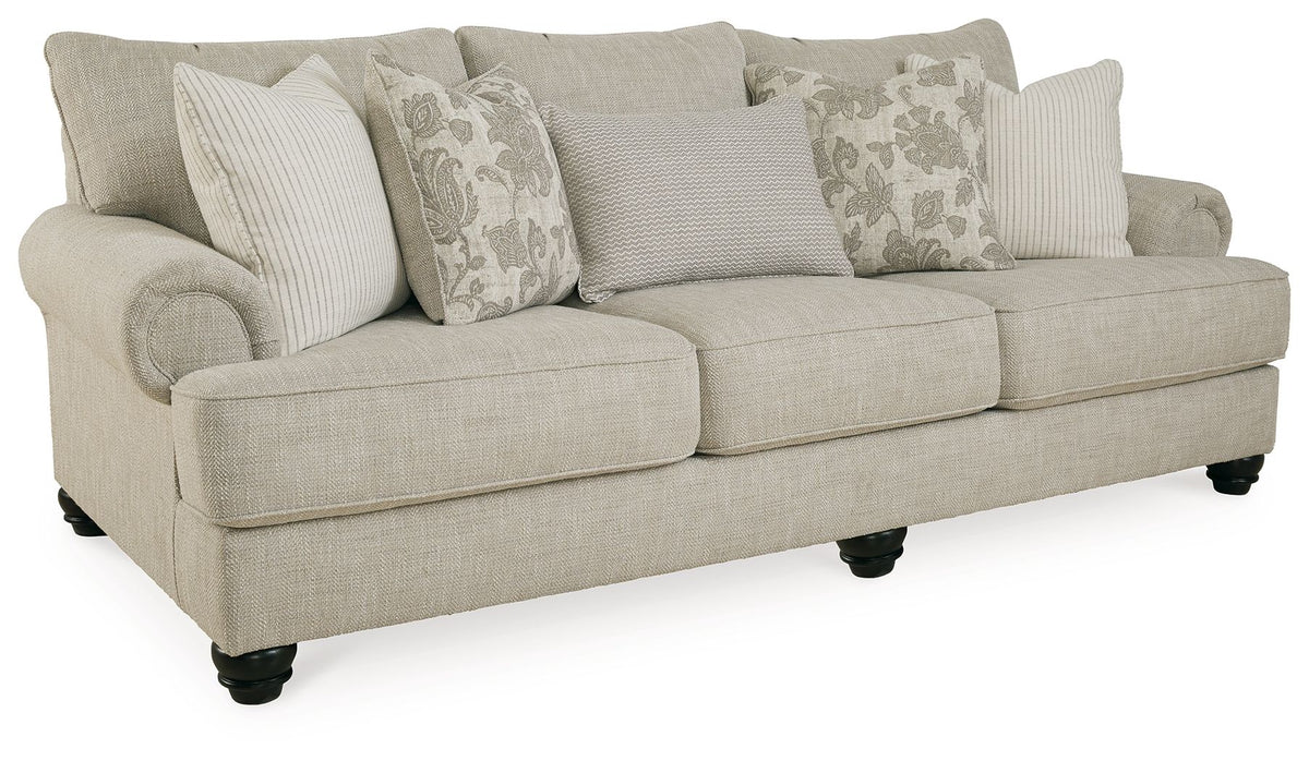 Fog sofa angled view in light beige fabric with dark legs and throw pillows