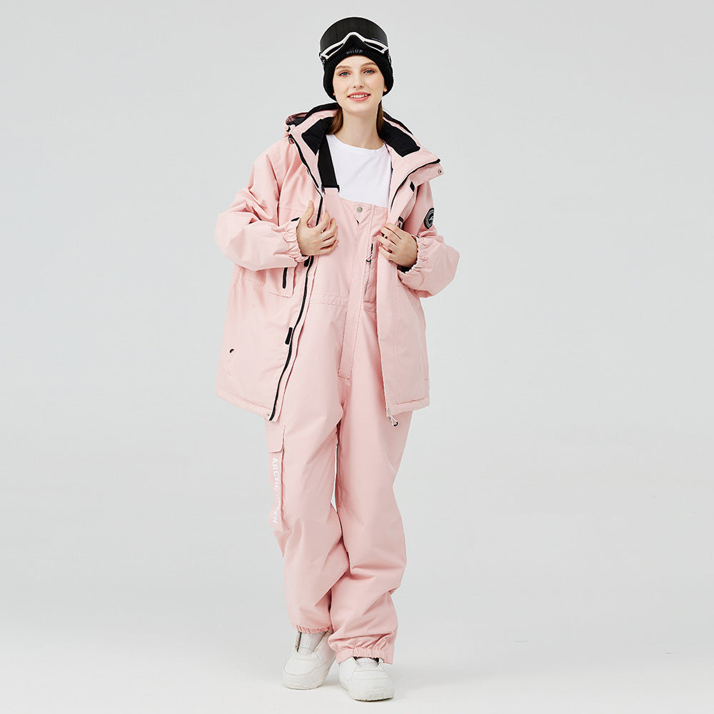 Pink winter ski suit with hooded jacket and matching snow pants, black trim and straps