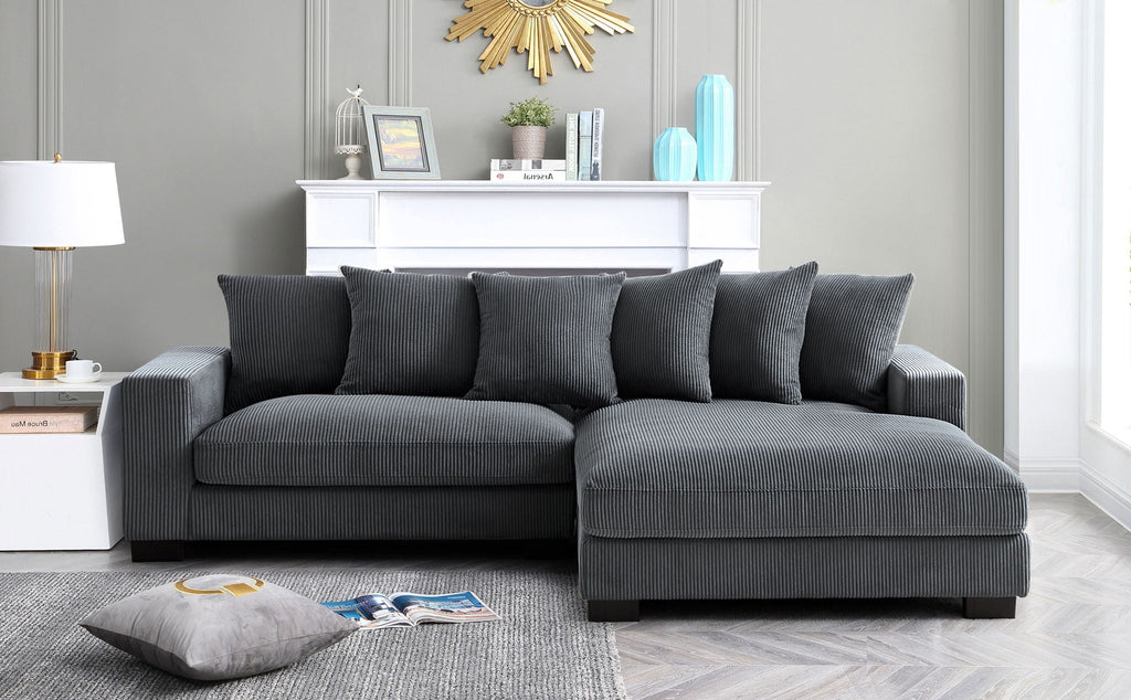 L-shaped sectional sofa with chaise in charcoal gray, coordinated cushions and back pillows