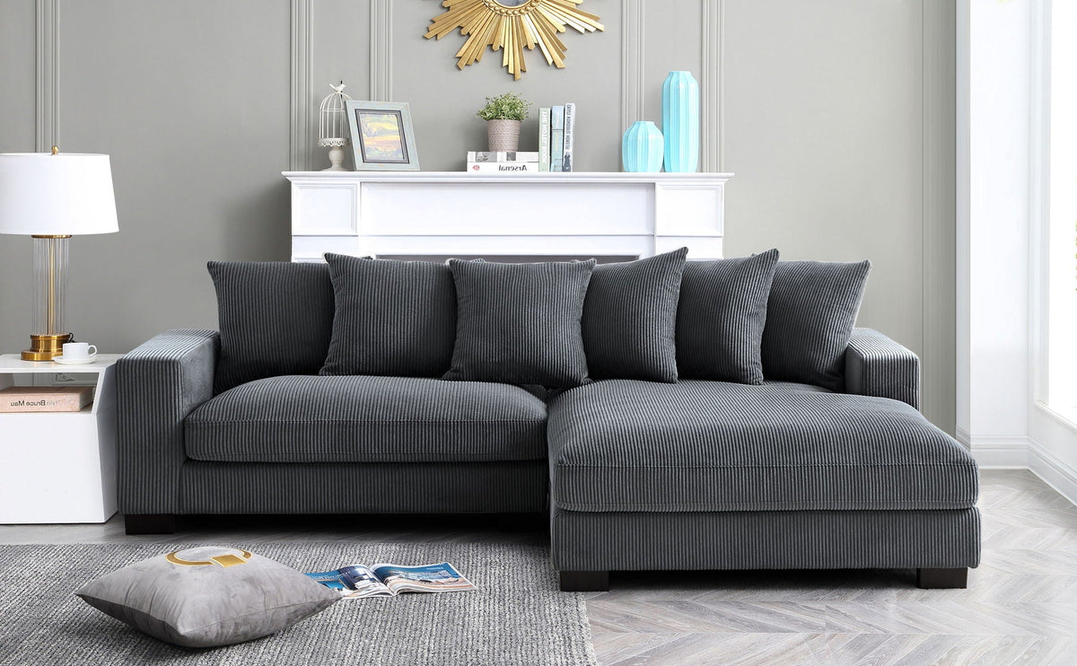 L-shaped sectional sofa with chaise in charcoal gray, coordinated cushions and back pillows
