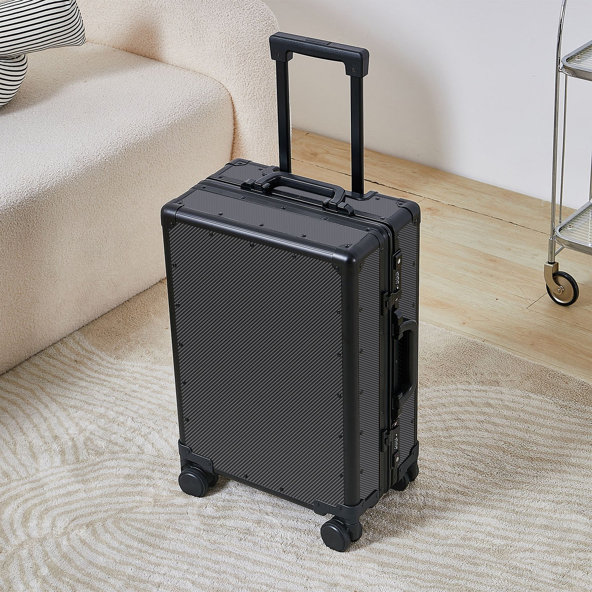 Large rolling suitcase with matte black hard shell, aluminum handle, and 4 wheels