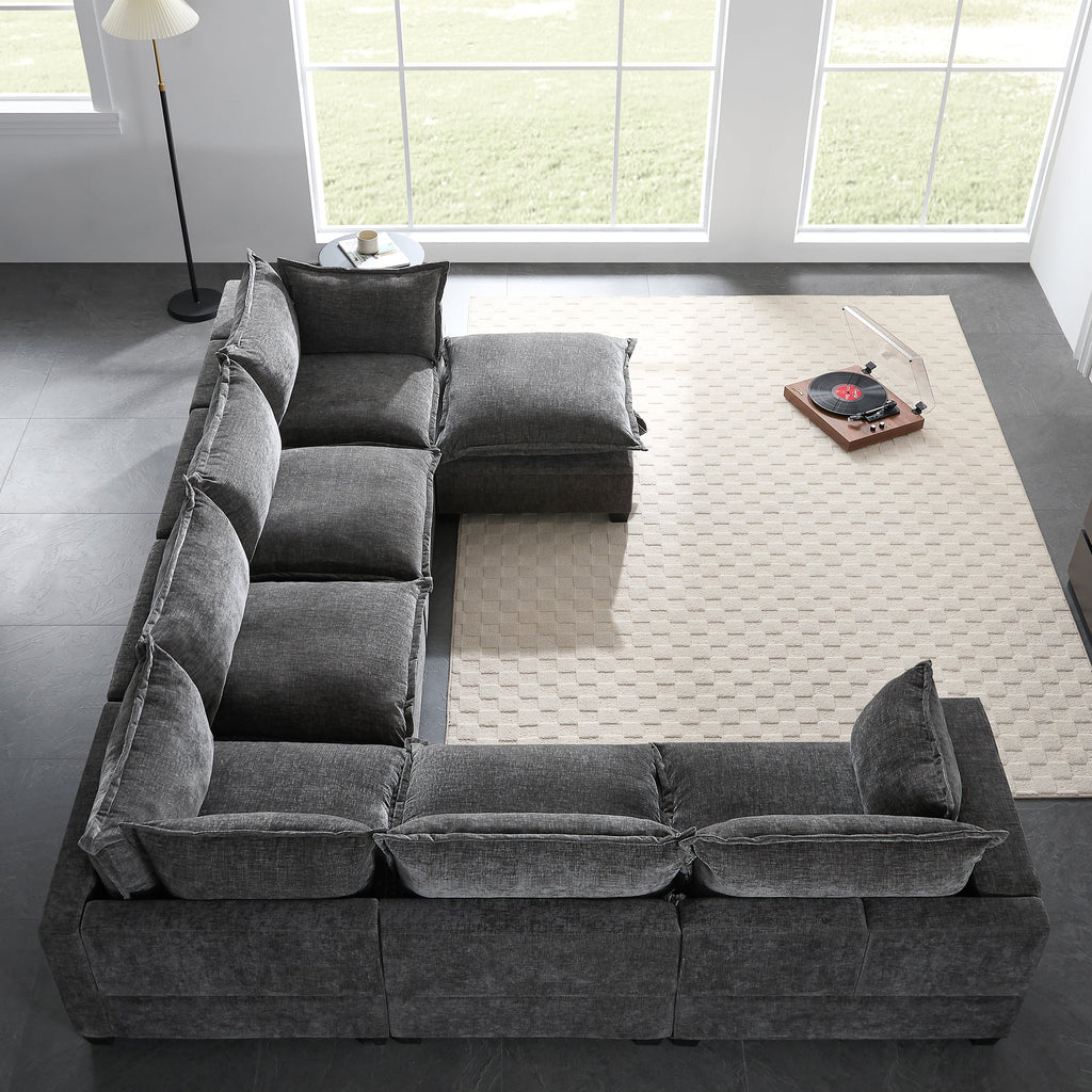 Dark gray chenille modular sectional sofa with chaise and movable storage ottoman seats.