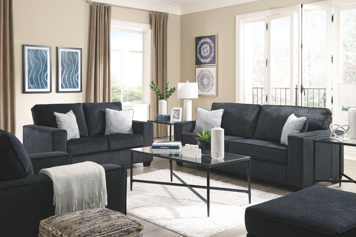 Dark gray upholstered sofa and loveseat set with throw pillows