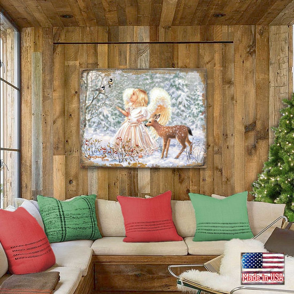 Framed wooden wall art above sofa featuring angel girl and deer in snowy winter scene