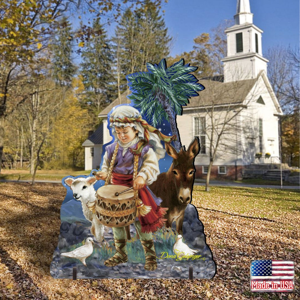 Nativity outdoor decor scene: drummer boy with drum, donkey, and lamb under blue palm