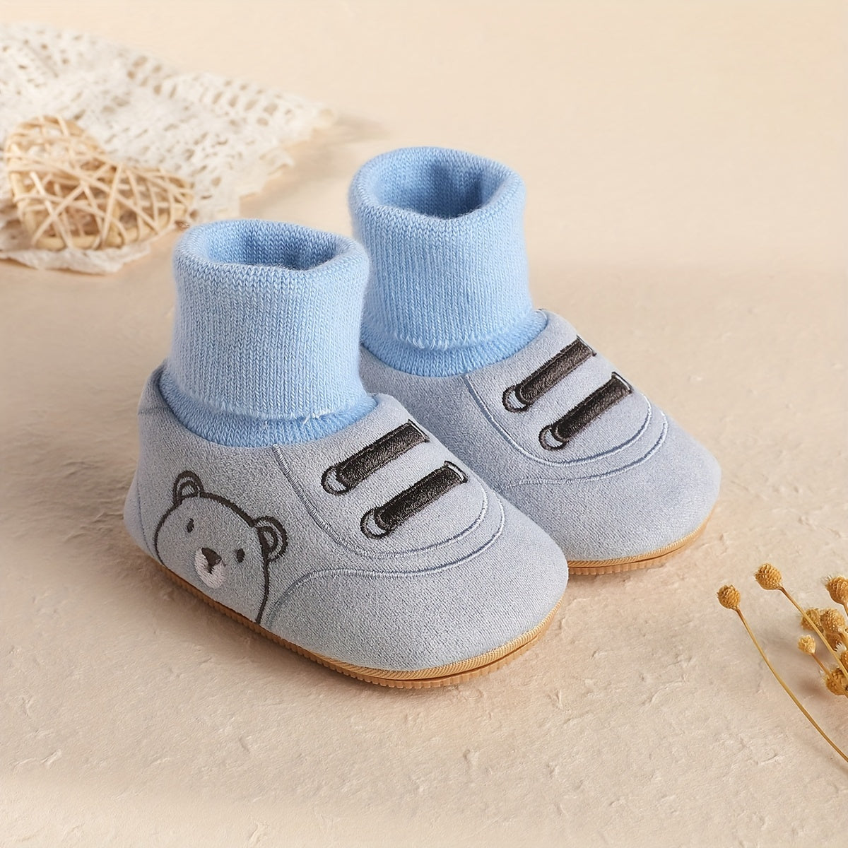 Light blue baby fleece-lined sock booties with bear face and non-slip sole
