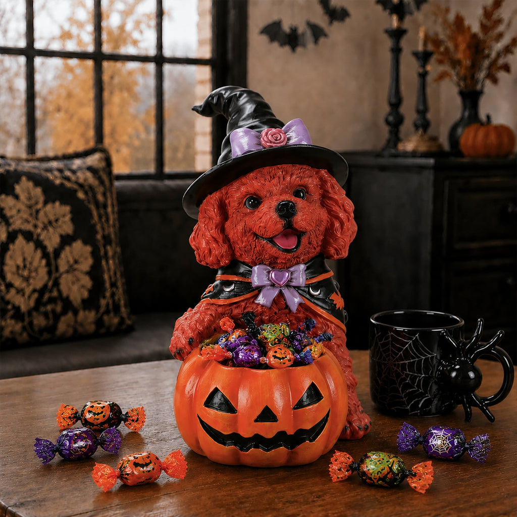 Front view of a brown dog witch figurine with a candy-filled pumpkin bowl