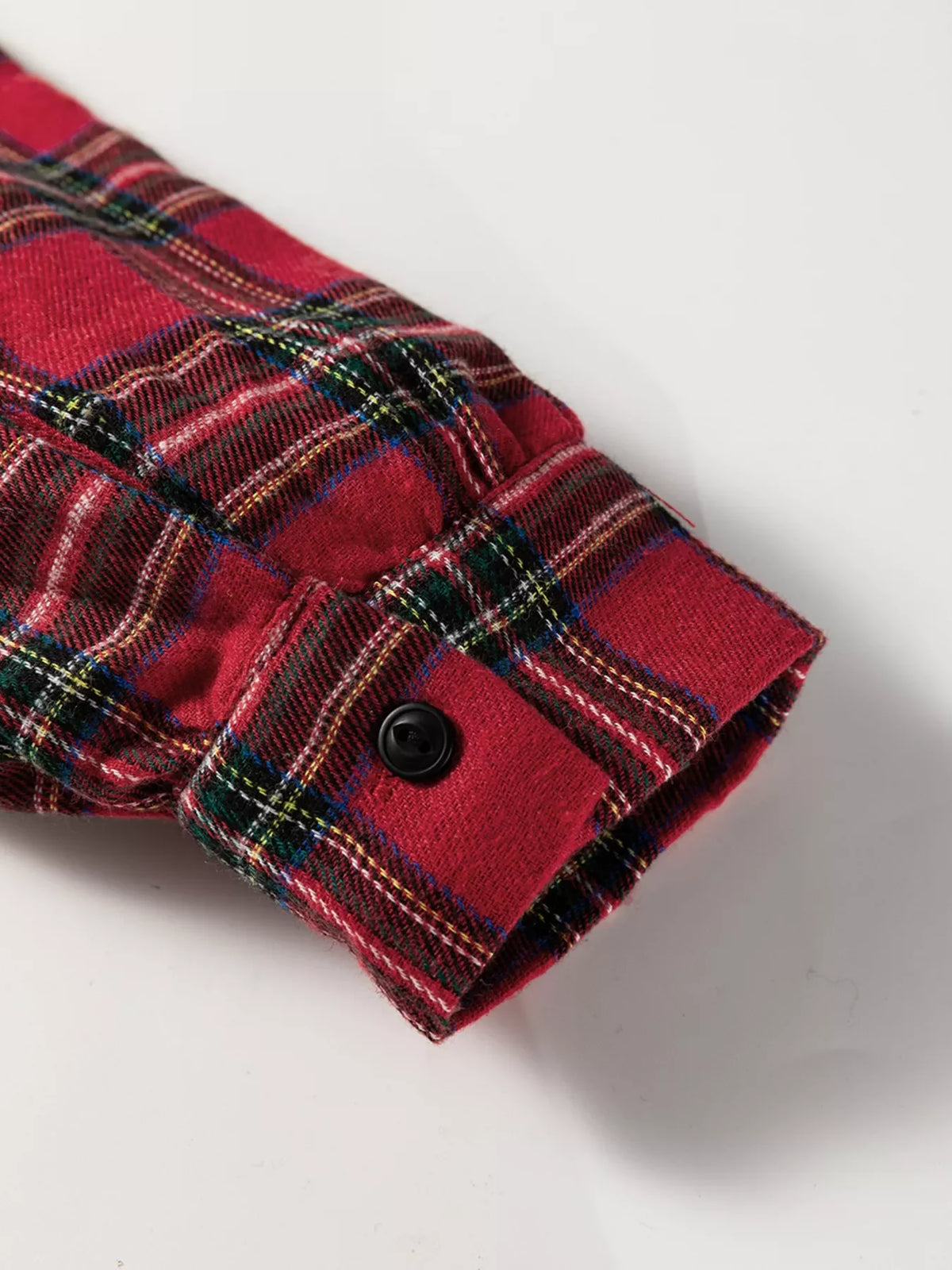 Burgundy plaid long-sleeve cuff with dark button, folded hem detail