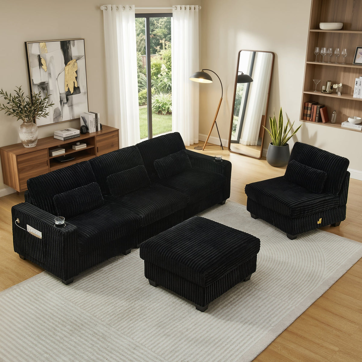 Black corduroy sectional sofa with chaise and matching ottoman, side view
