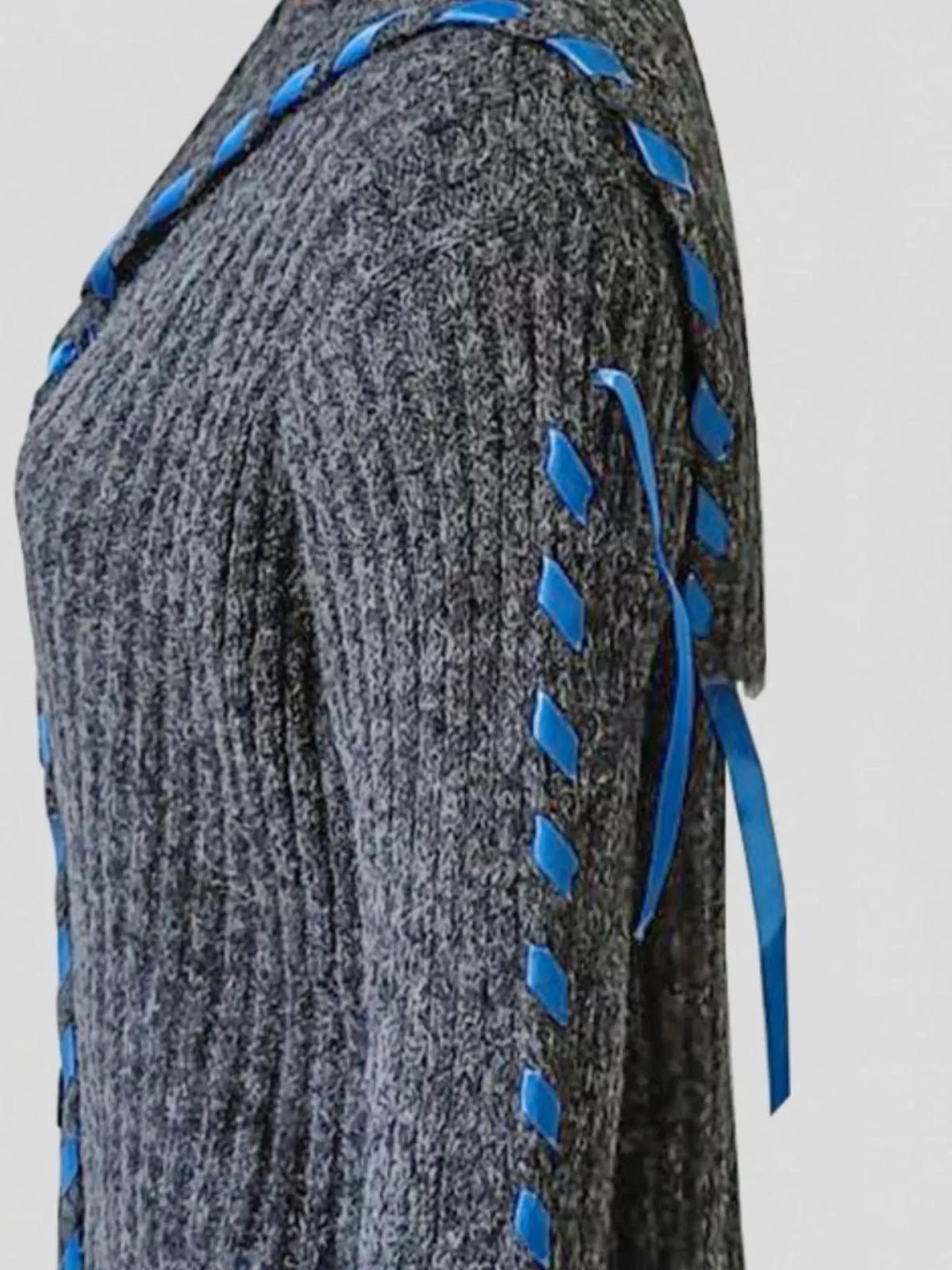 Gray ribbed knit cardigan with blue ribbon-like tie trim along sleeve and side