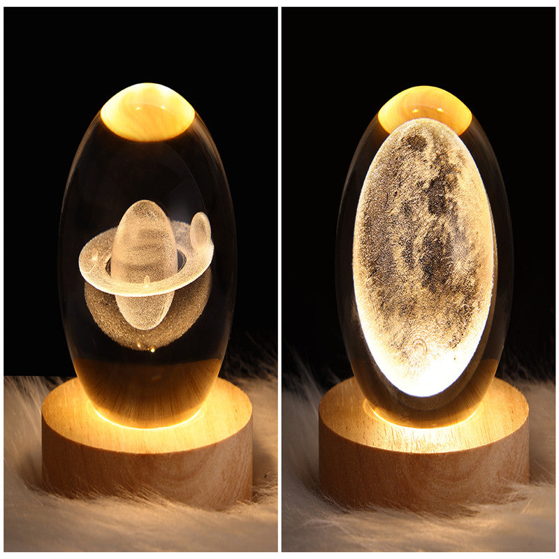 Two galaxy crystal ball table lamps showing glowing planet and moon scenes in glass globes