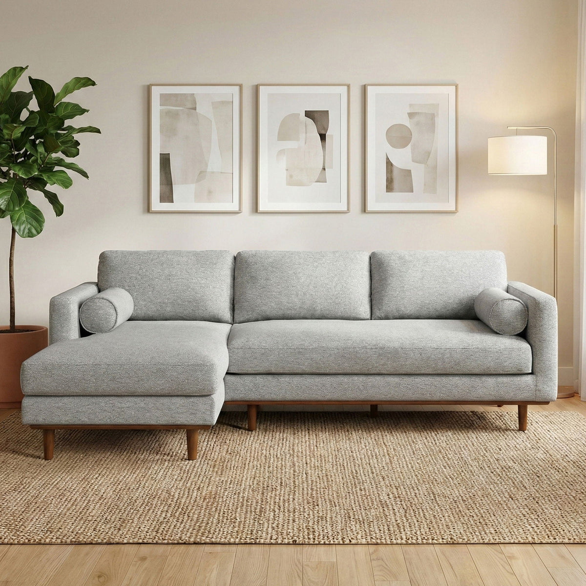 Gray upholstered sectional sofa with chaise and pillow-style back cushions