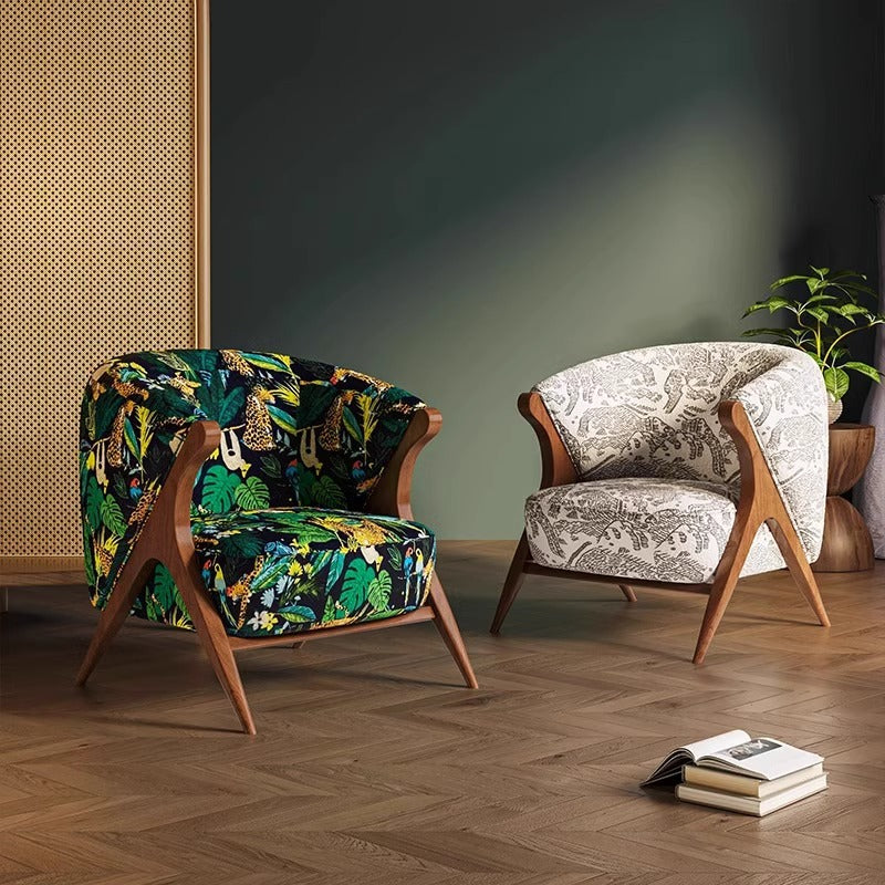 Tropical-print lounge chair with wood frame, armrests, and curved barrel back