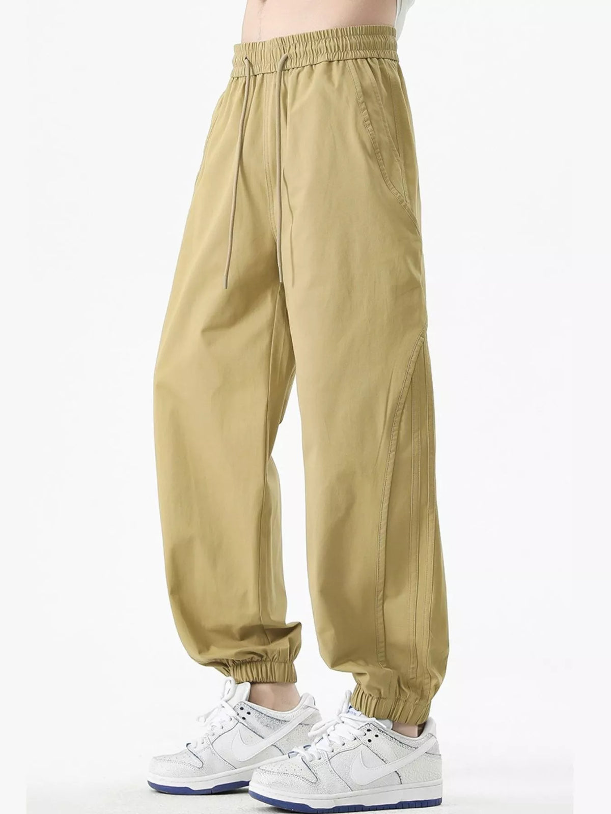 Khaki loose-fit drawstring casual pants with elastic waist and ankle cuffs, side pockets