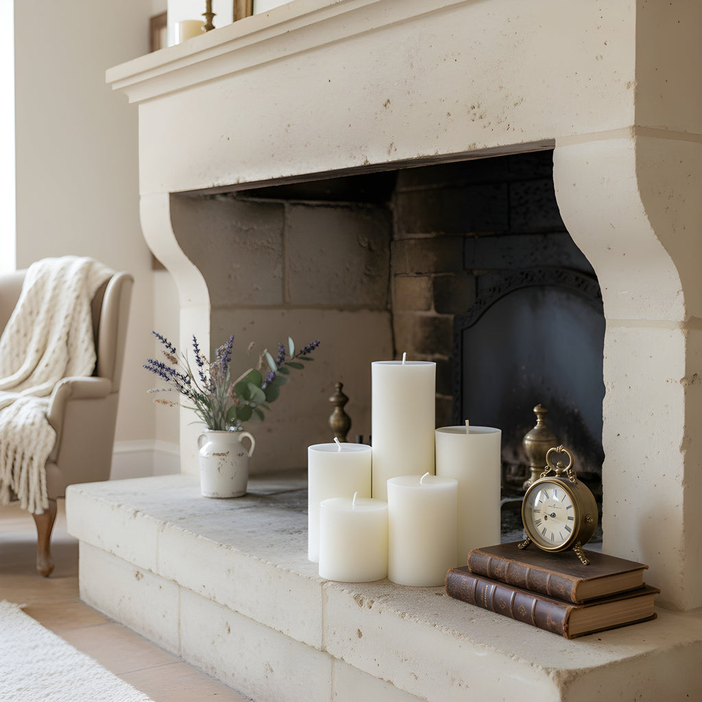 White pillar candles arranged on fireplace mantel, 5 cylinders, unlit