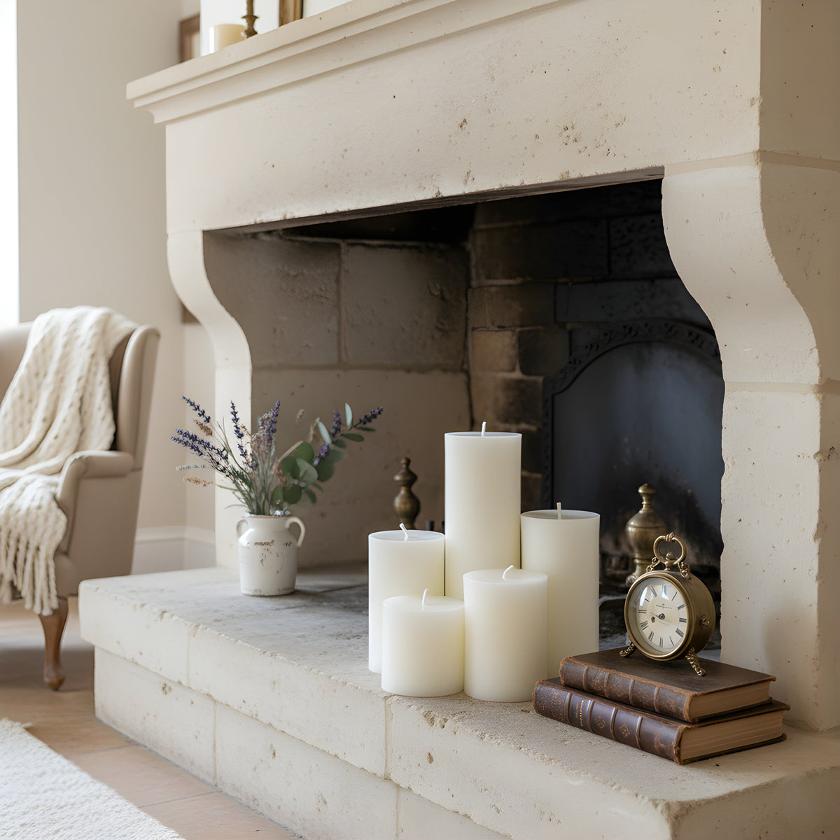 White pillar candles arranged on fireplace mantel, 5 cylinders, unlit