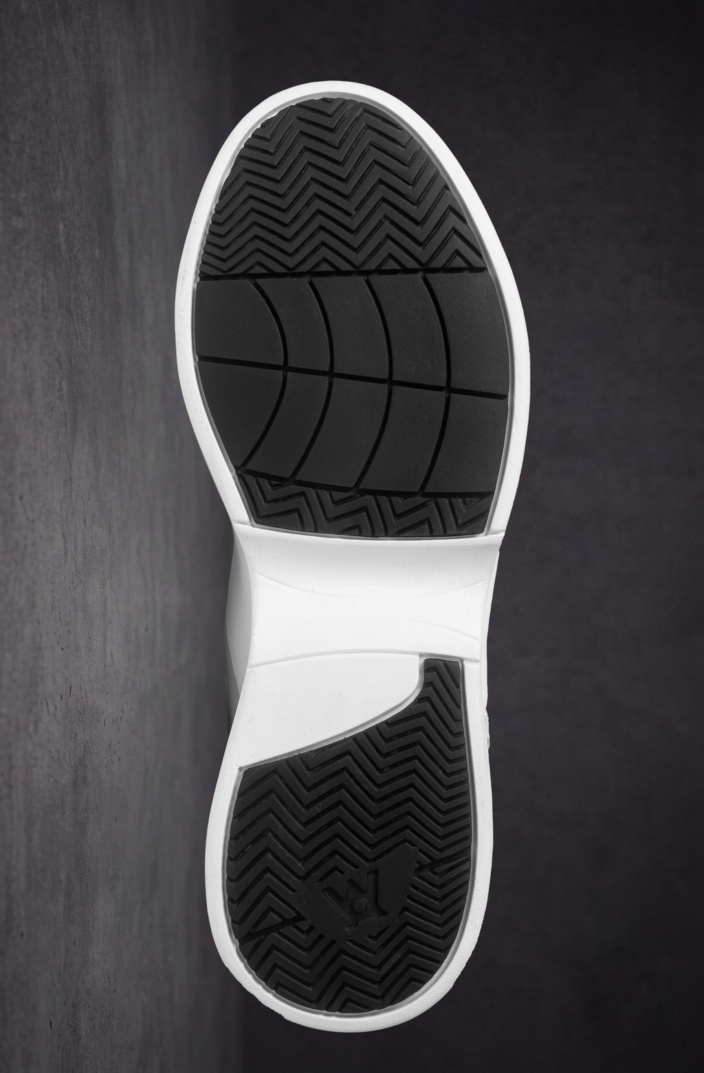 White outsole view with textured traction tread and grid pattern