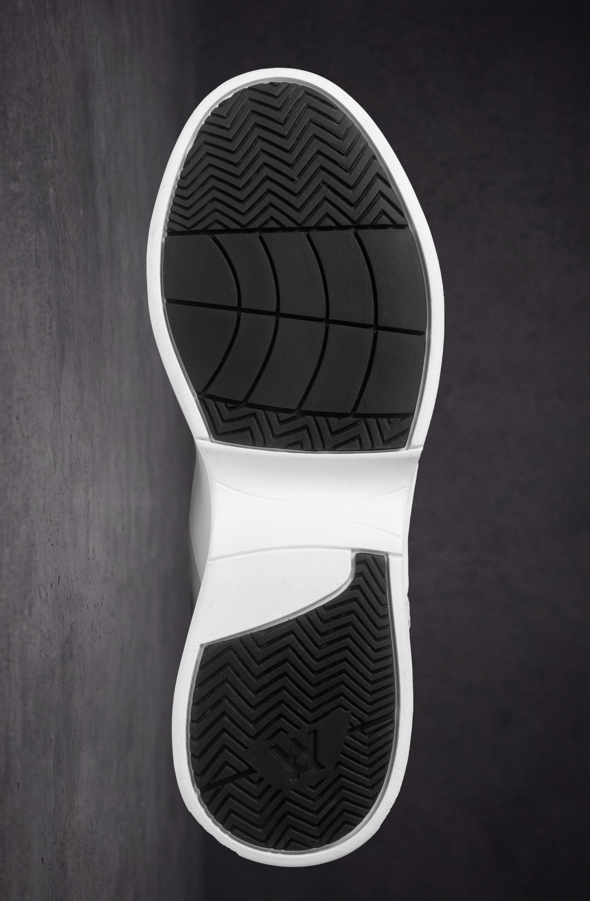 White outsole view with textured traction tread and grid pattern