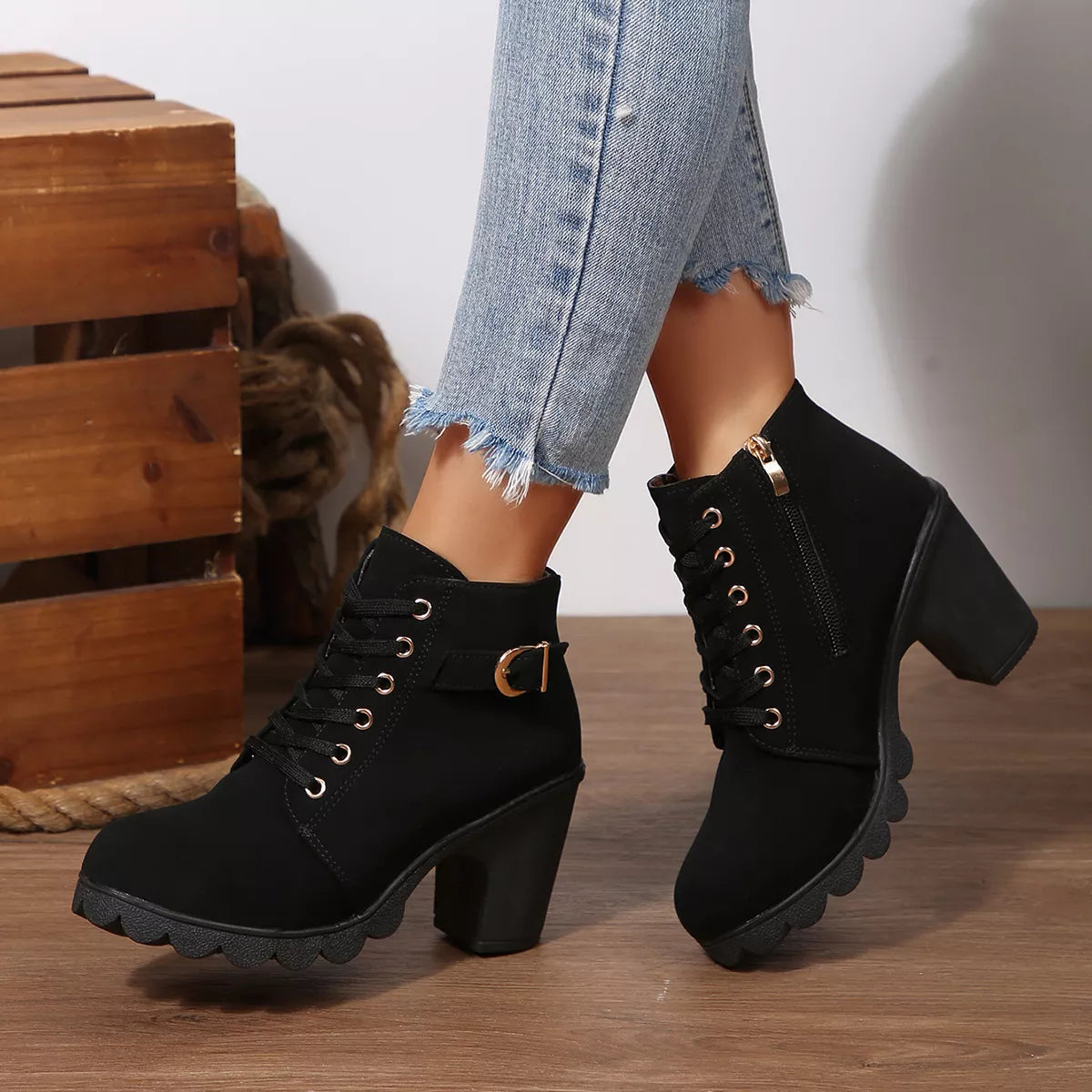 Black lace-up ankle boots with chunky heel, buckle collar strap and thick tread sole