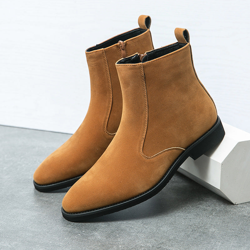Pair of tan suede chelsea boots with elastic side panels and chunky black sole