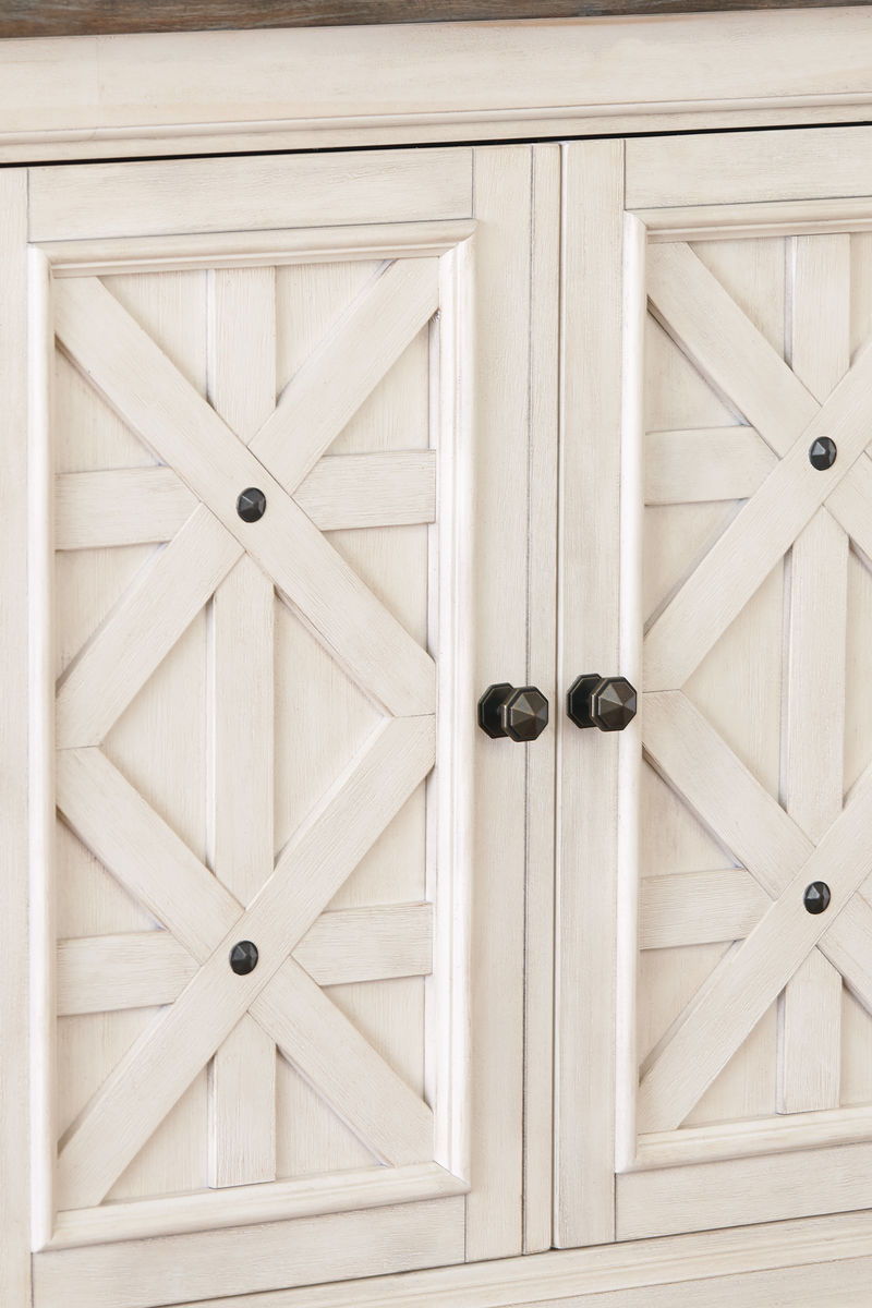 Beige cabinet doors with crosshatch panels and black knobs on rectangular display unit.