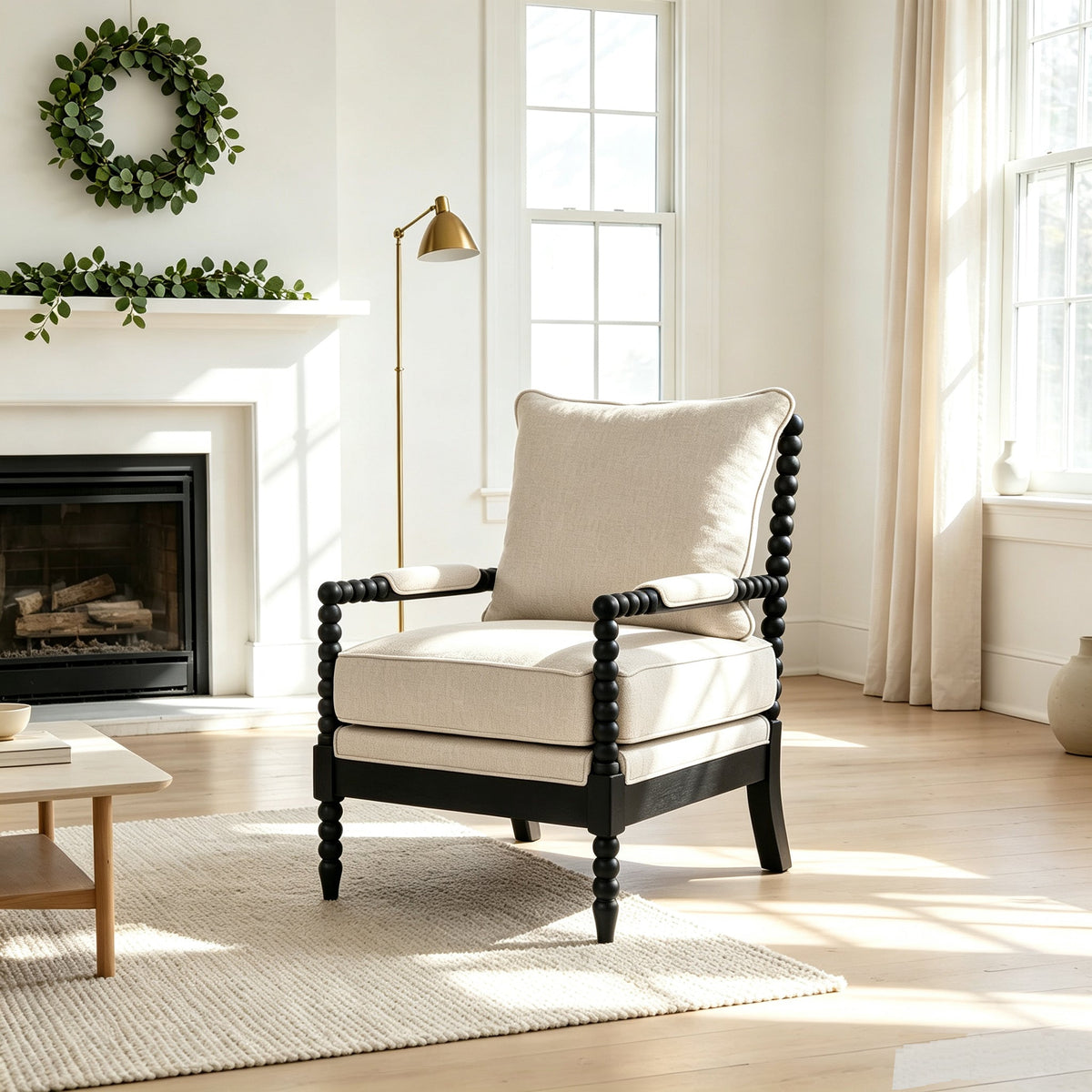 Cream upholstered accent chair with a black beaded wood frame and padded arms