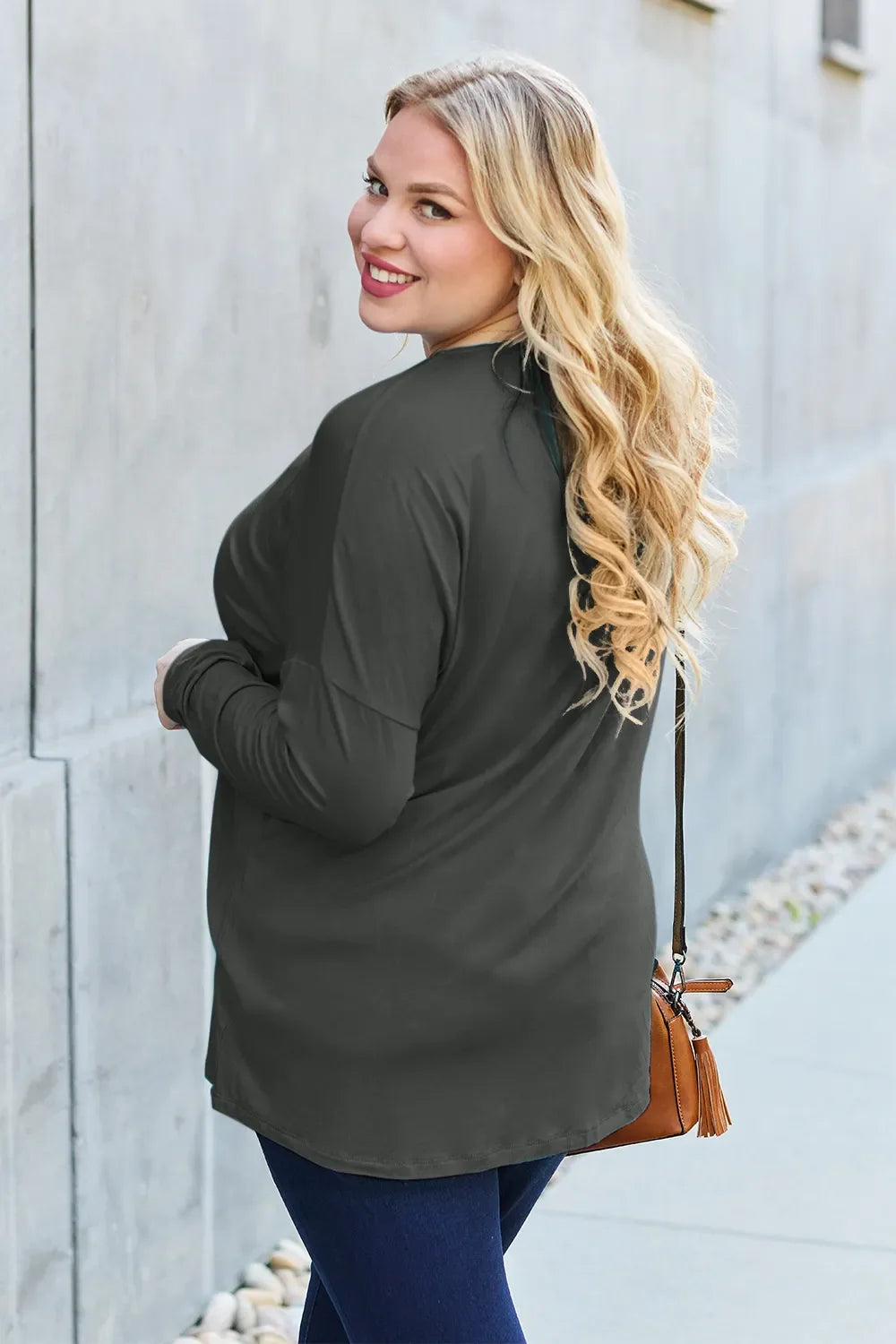 Black relaxed long-sleeve tee with crew neck and loose fit, side view