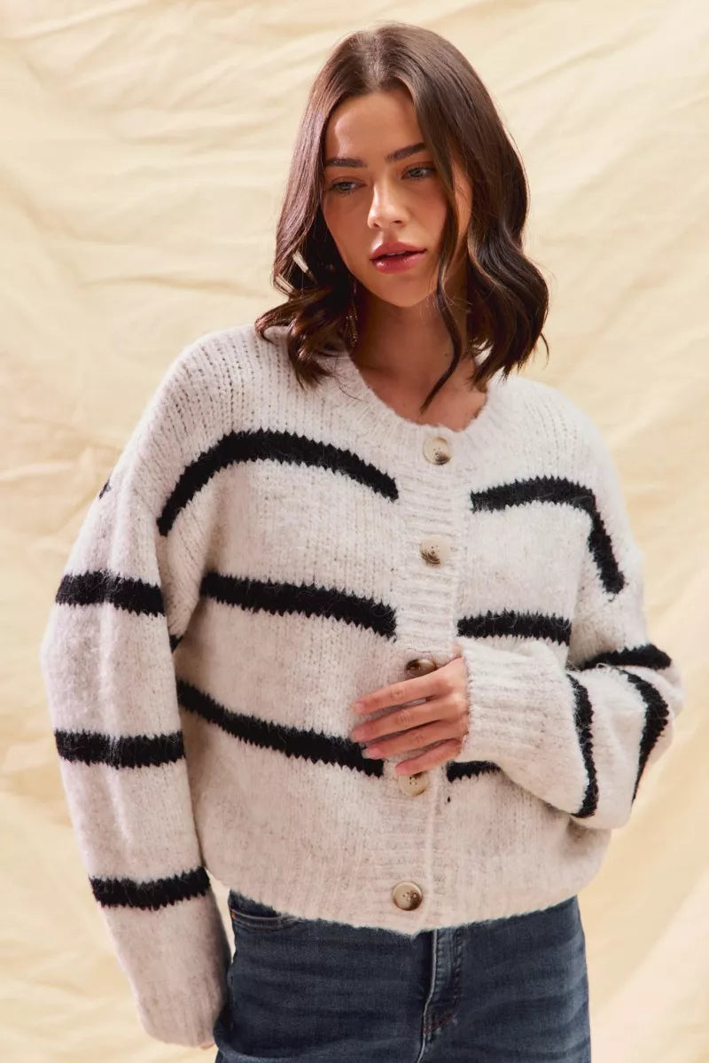 Cream striped cardigan sweater with button placket and horizontal black stripe bands